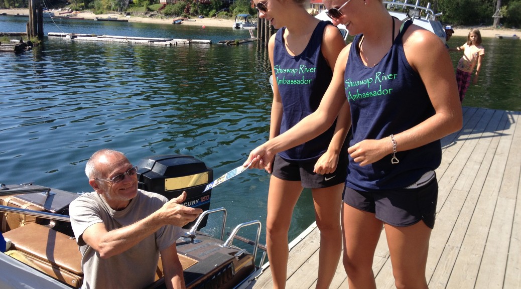 River Ambassadors distributing information material to a boater about zebra and quagga mussels
