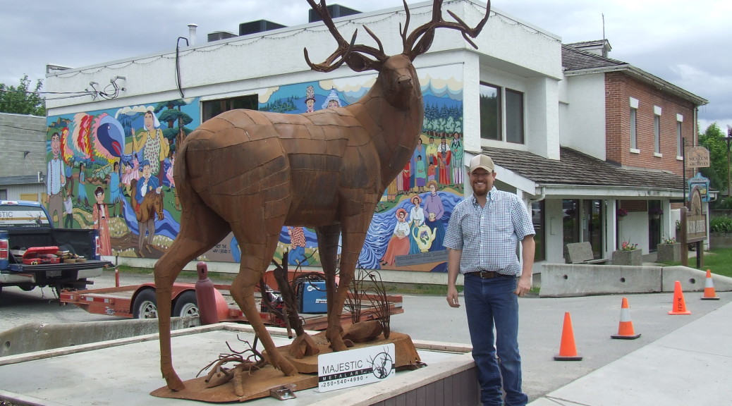 Braden Kiefiuk, artist, alongside his deer sculpture in Enderby