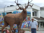 Artist Braden Kiefiuk alongside his deer sculpture in Enderby