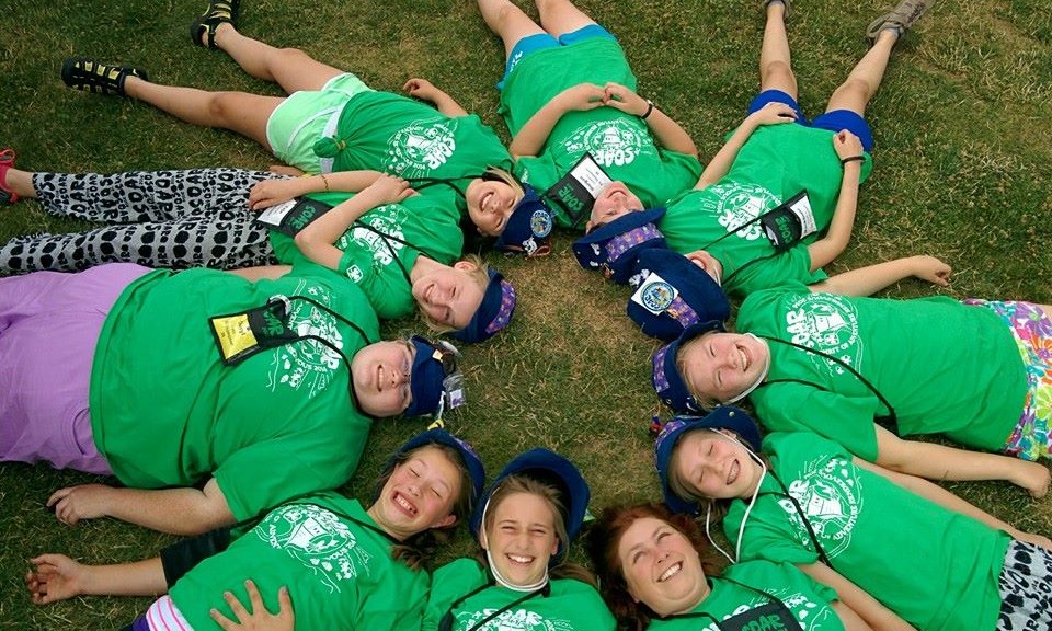 Girl Guides in a circle looking at the sky