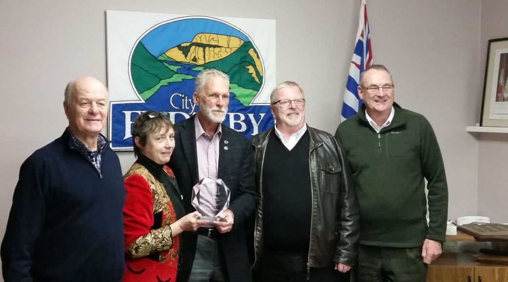 Rick Fairbairn, Rhona Martin, Eric Foster, and Colin Mayes present Earl Shipmaker with an award for 35 years of local government service.