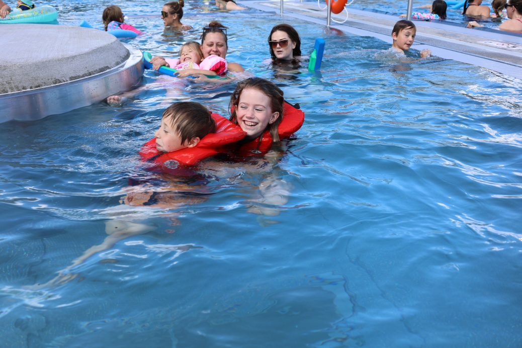 Boy & girl laughing in lazy river